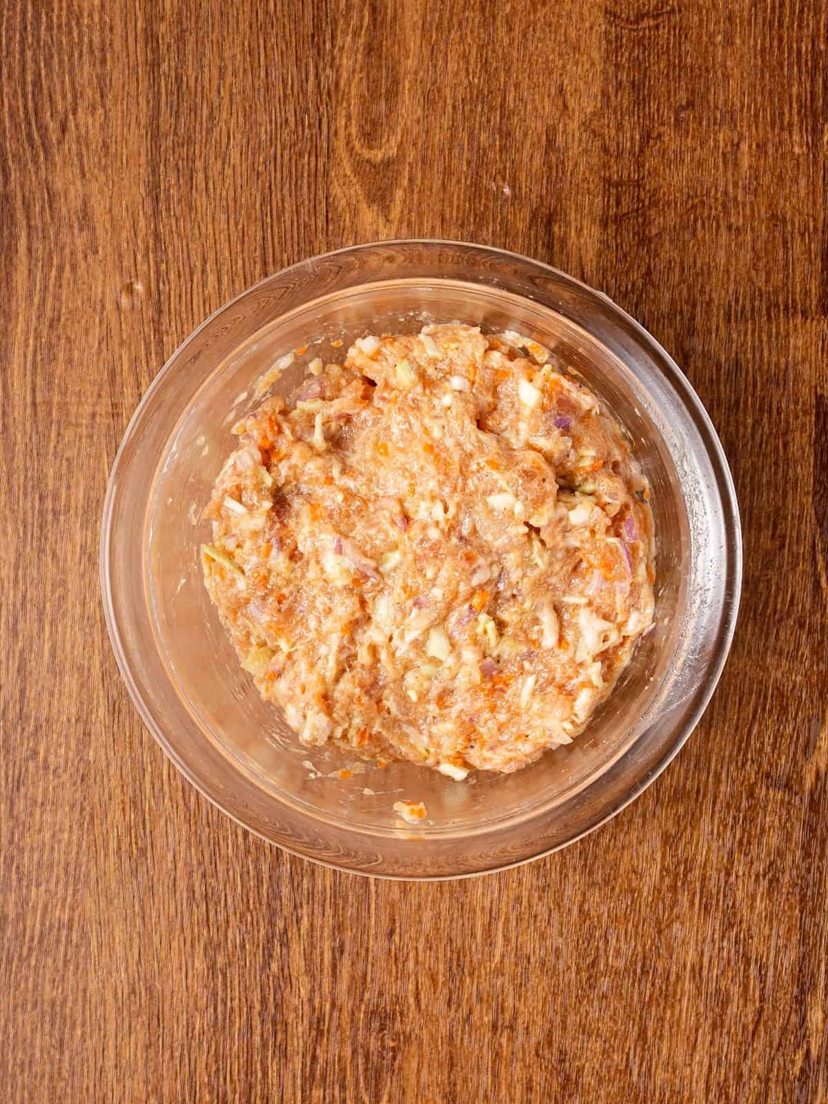 Filipino lumpia filling mixed together in a glass bowl