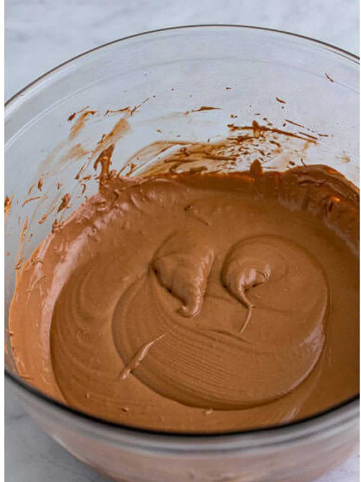 Hot chocolate dip base mixed until smooth and creamy in a glass bowl.