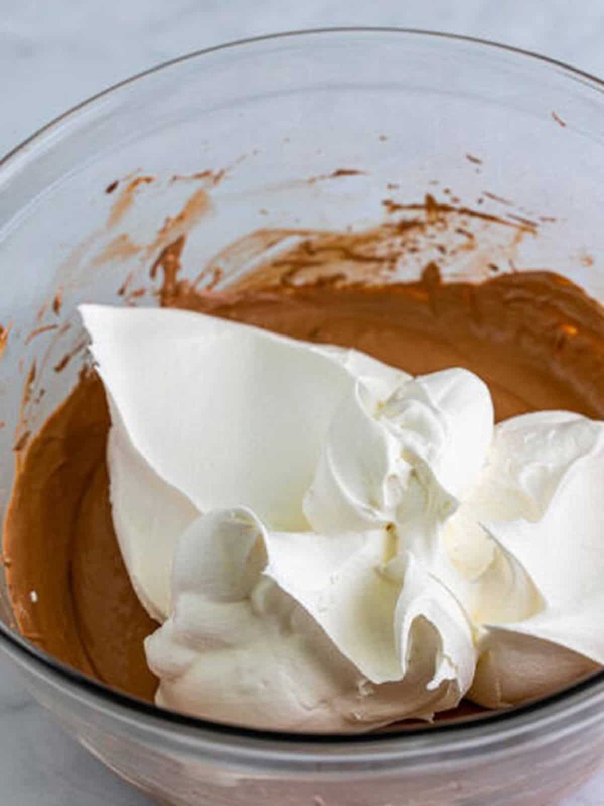 Whipped topping added to the hot chocolate dip base before folding in.