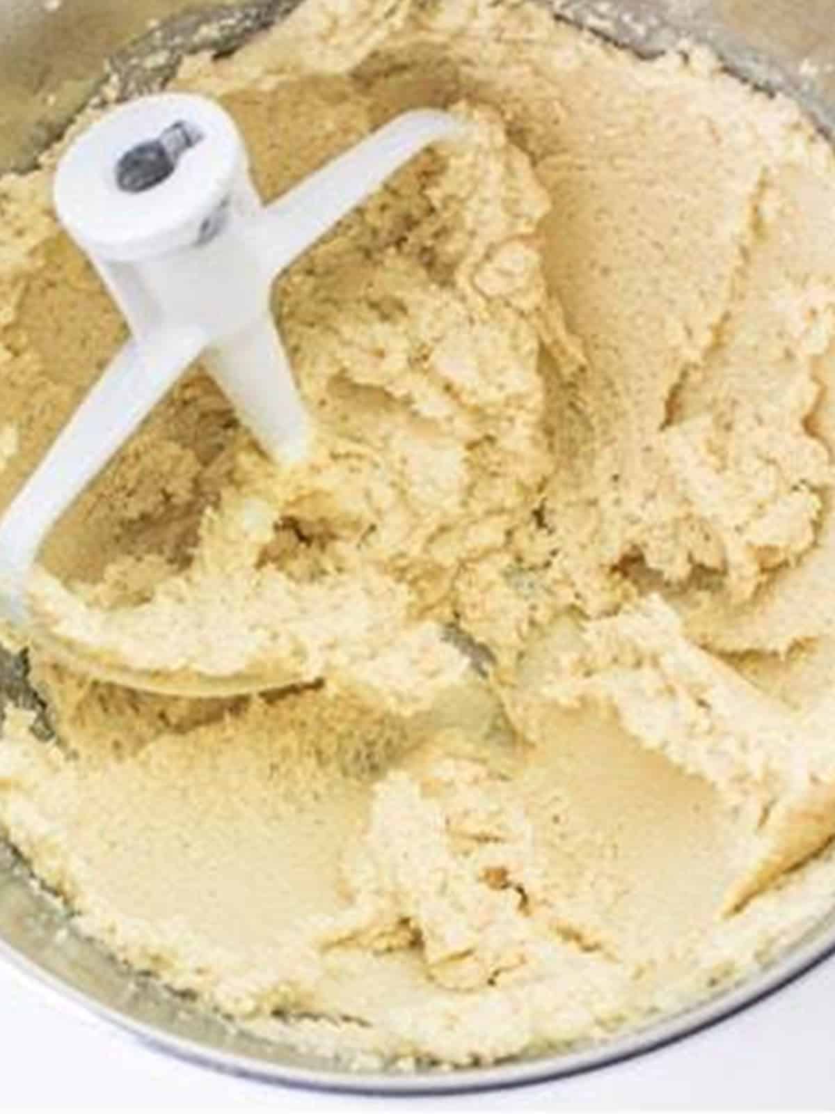 Butter and sugars creamed together until light and fluffy for pumpkin cookies.