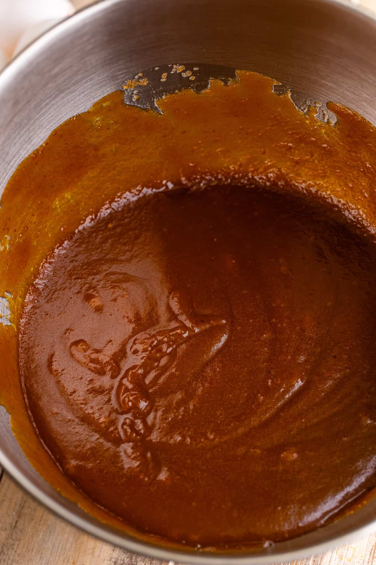 Pumpkin puree, dark brown sugar, and oil whisked together in a mixing bowl.