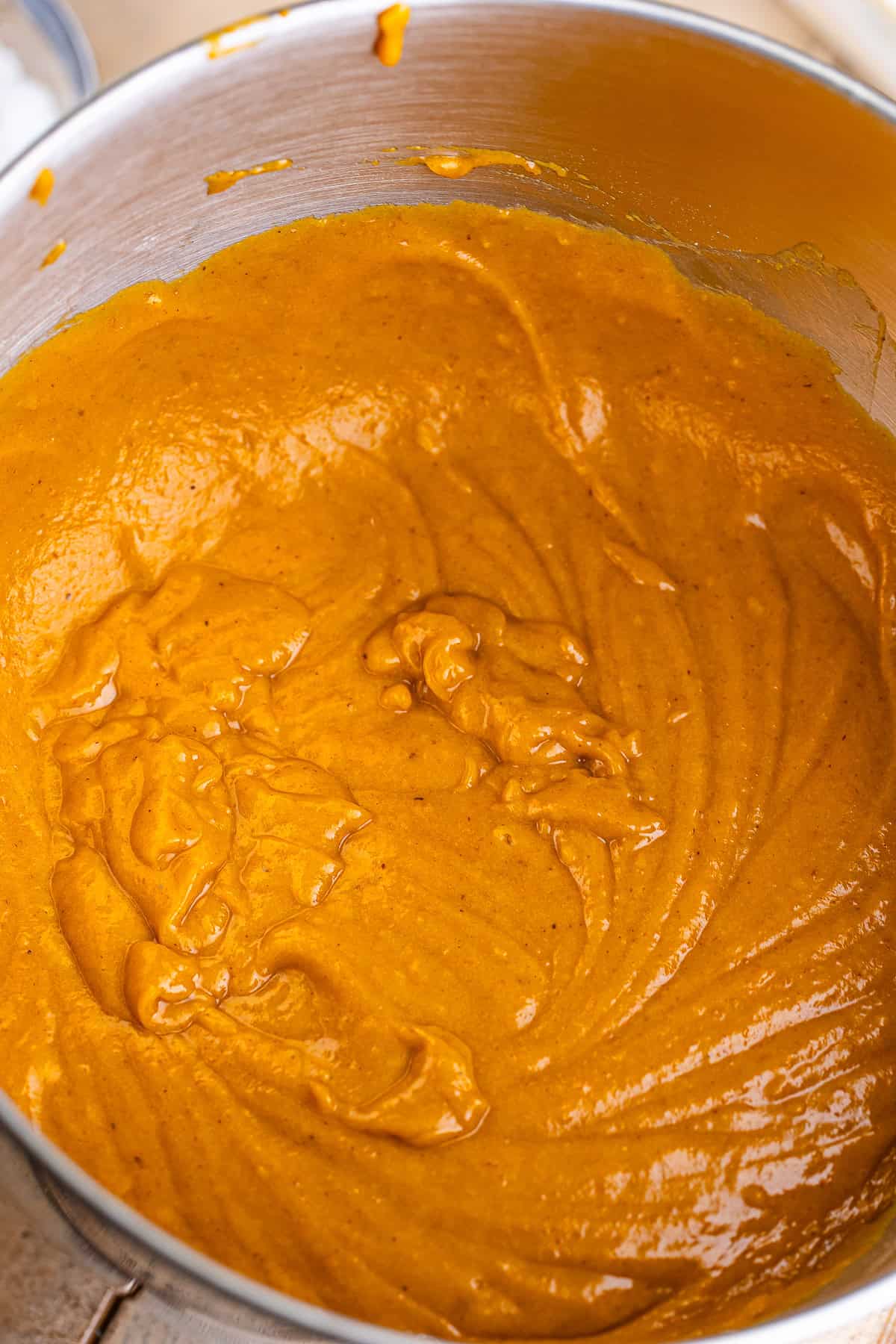 Smooth pumpkin spice cake batter after the dry ingredients are stirred in.