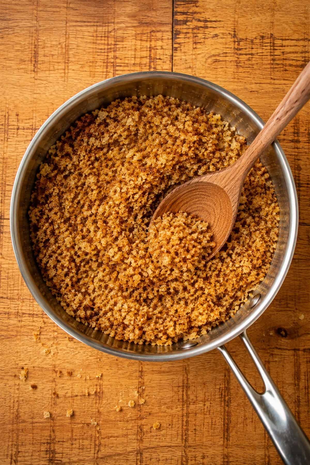 Golden brown panko breadcrumbs toasted with butter in a small skillet.