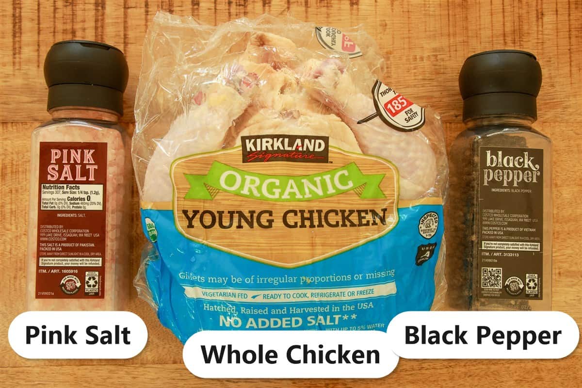 Labeled ingredients for smoked spatchcock chicken including a whole chicken, pink salt, and black pepper.