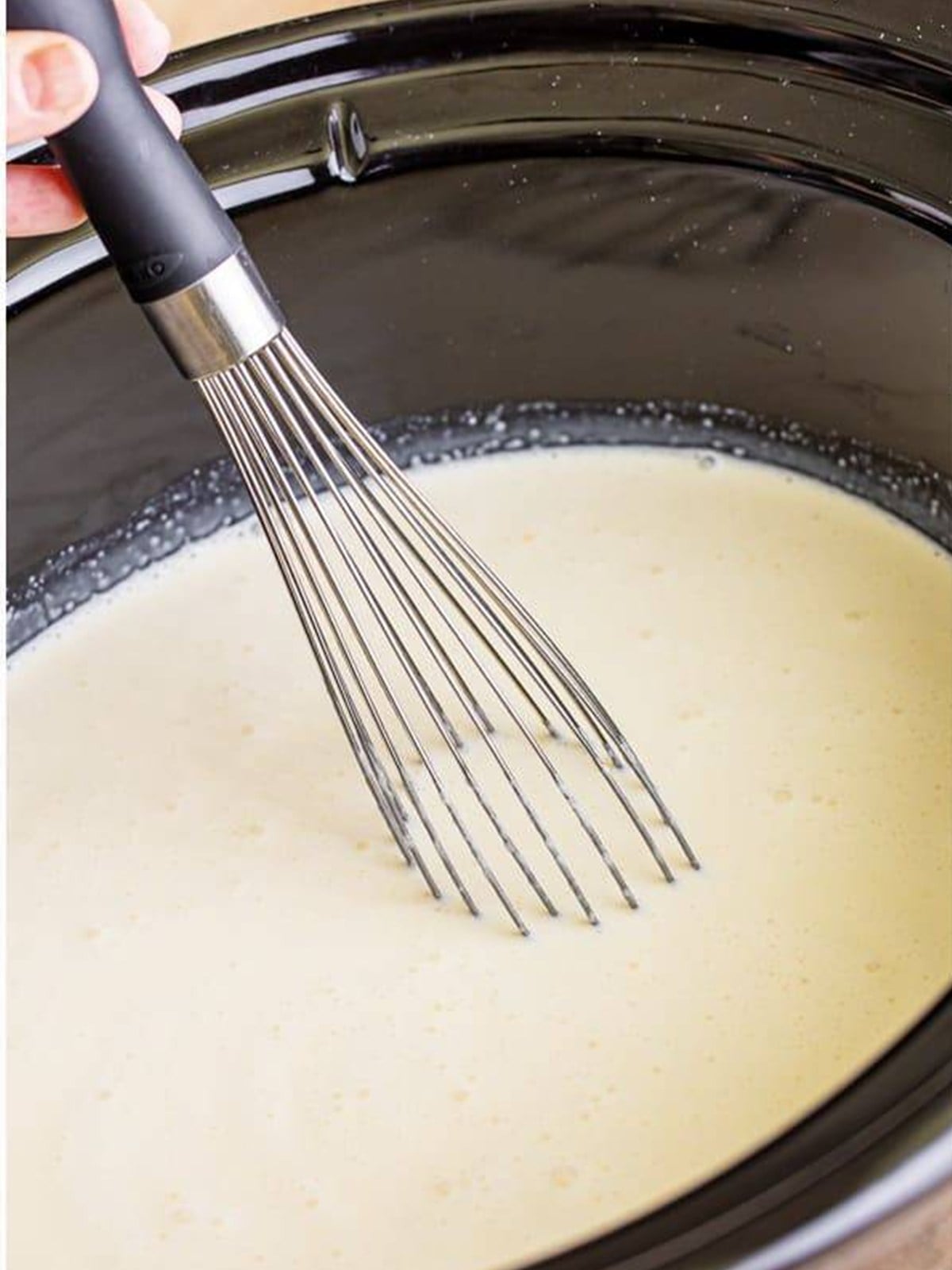 Whisking the Witches Brew hot chocolate until the white chocolate is fully melted and smooth.