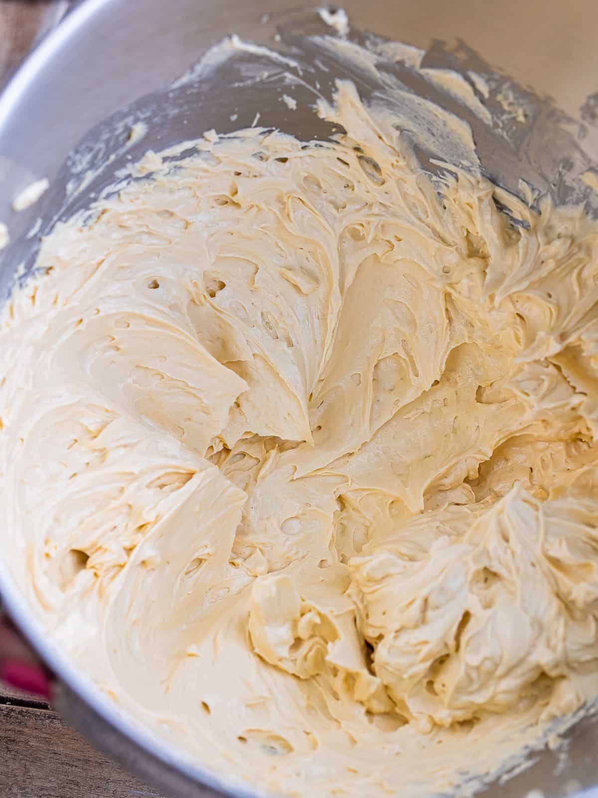 Whipped brown sugar ermine frosting in a mixing bowl, light and fluffy like whipped cream.