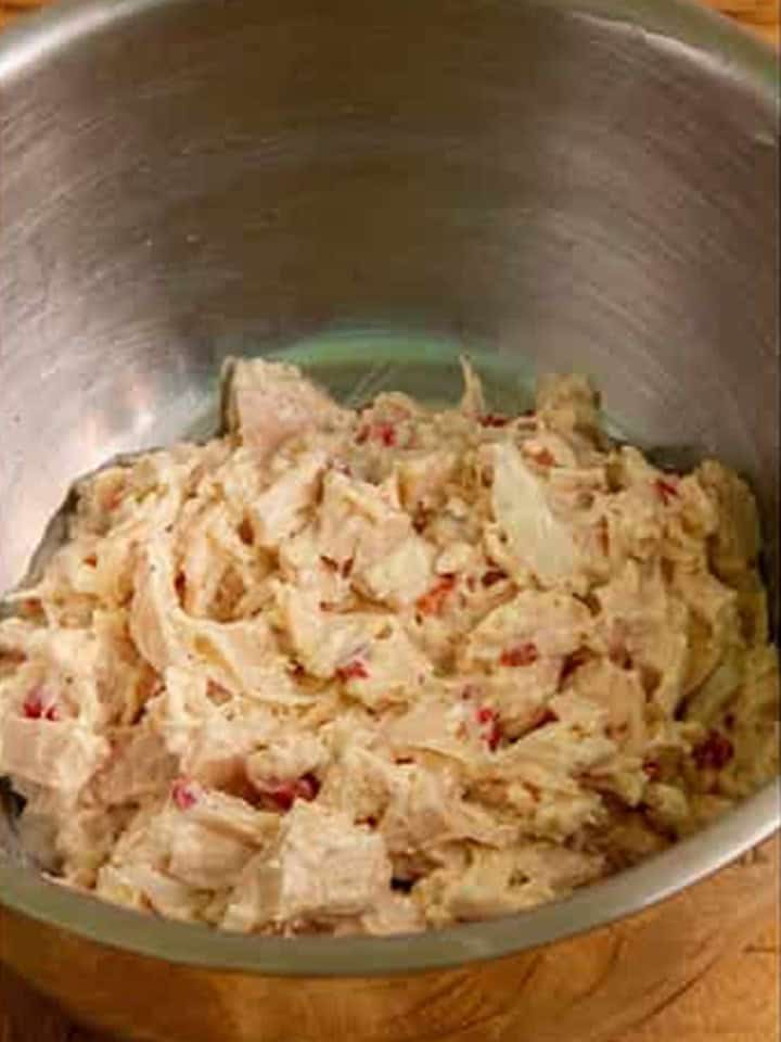 Creamy chicken filling for crescent rolls fully mixed together in a bowl.