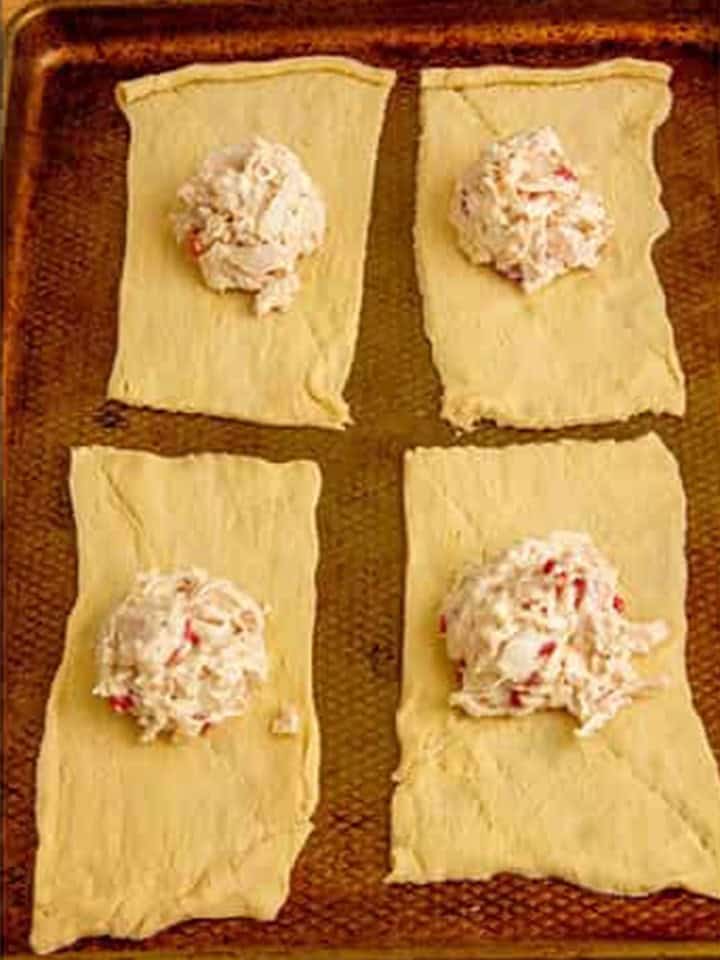 Creamy chicken filling spooned onto the center of each crescent dough rectangle.