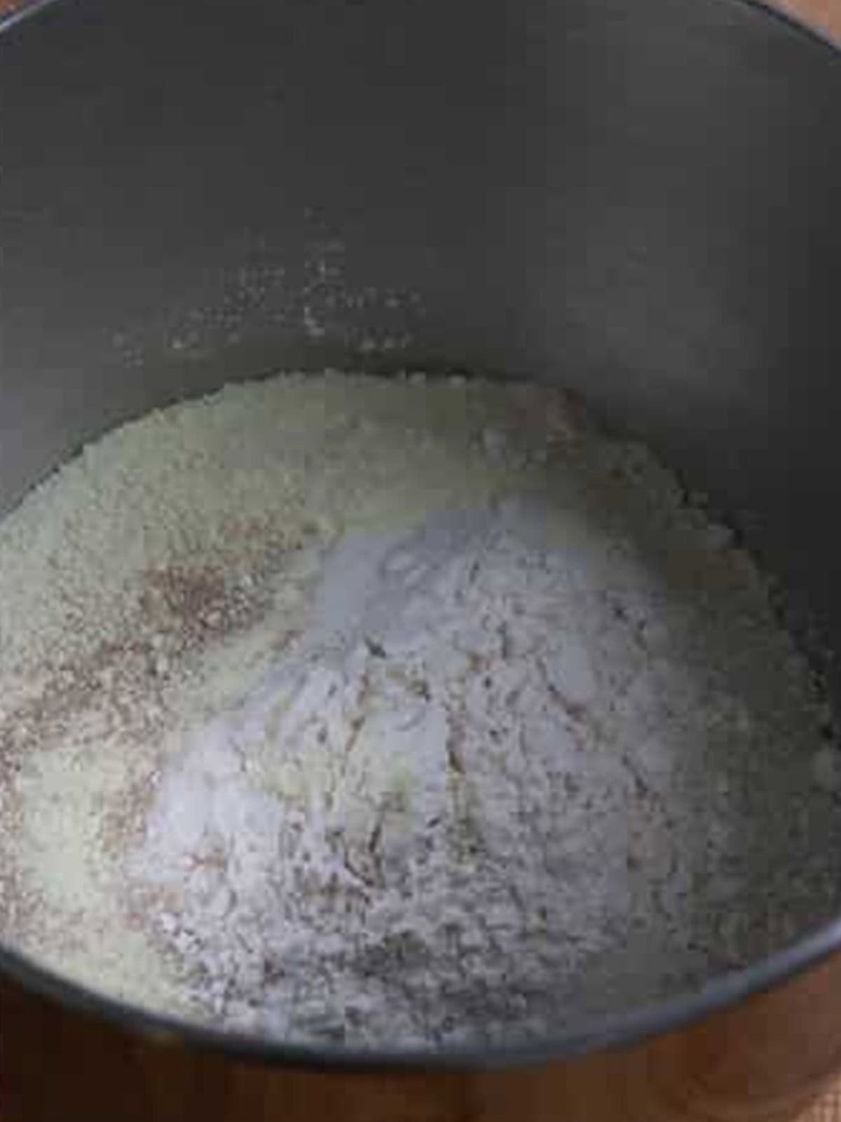 Bread flour, cake flour, sugar, salt, milk powder, and yeast in a stand mixer bowl for salt bread dough.