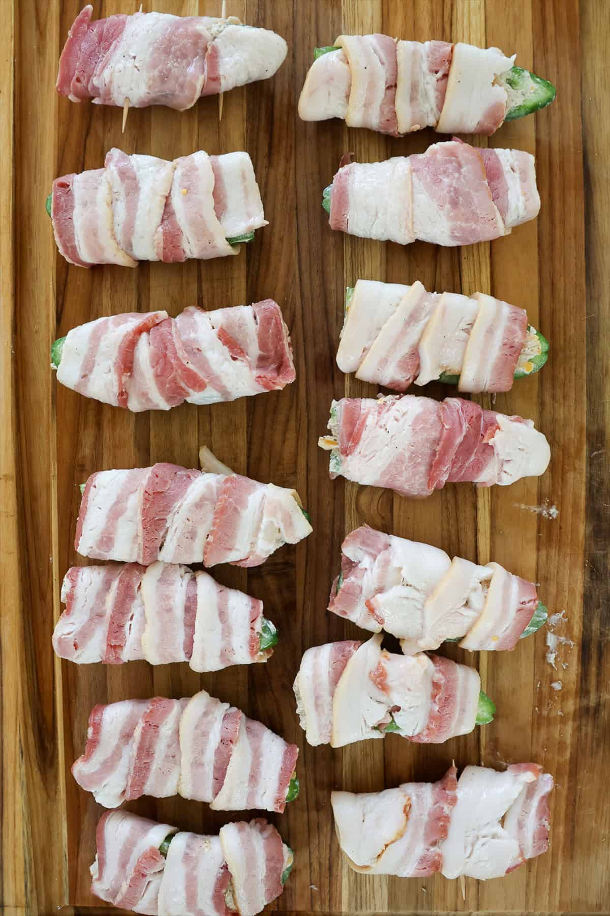 Bacon wrapped jalapeno poppers pinned with toothpicks before going on the smoker.