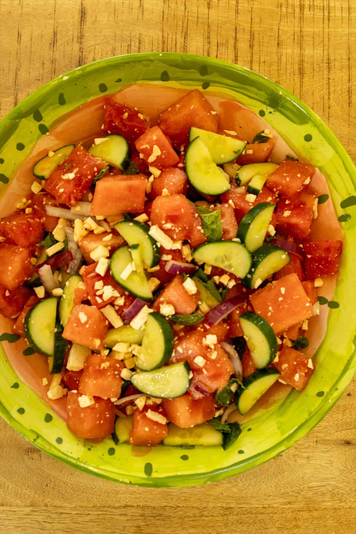 Overhead view of watermelon feta salad with cucumber, mint, and red onion tossed in honey lime dressing.
